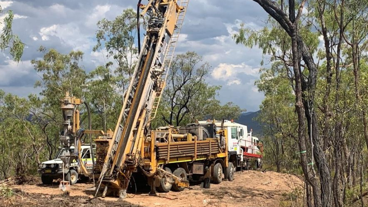 Mineral exploration drill rigs operating in a forested area in Queensland