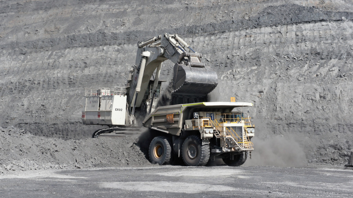 Heavy haul truck and excavator at Australian lithium mining site