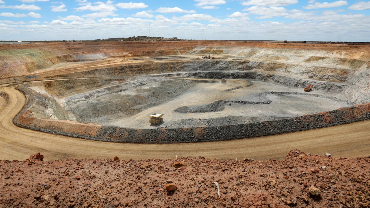 Open-pit mine with terraced excavation and heavy haul trucks