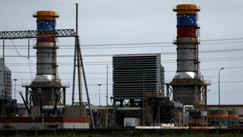 Twin industrial processing towers and plant infrastructure at a large energy and materials facility