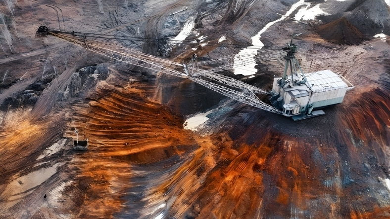 Large-scale mining excavator operating in an open-pit mineral extraction site